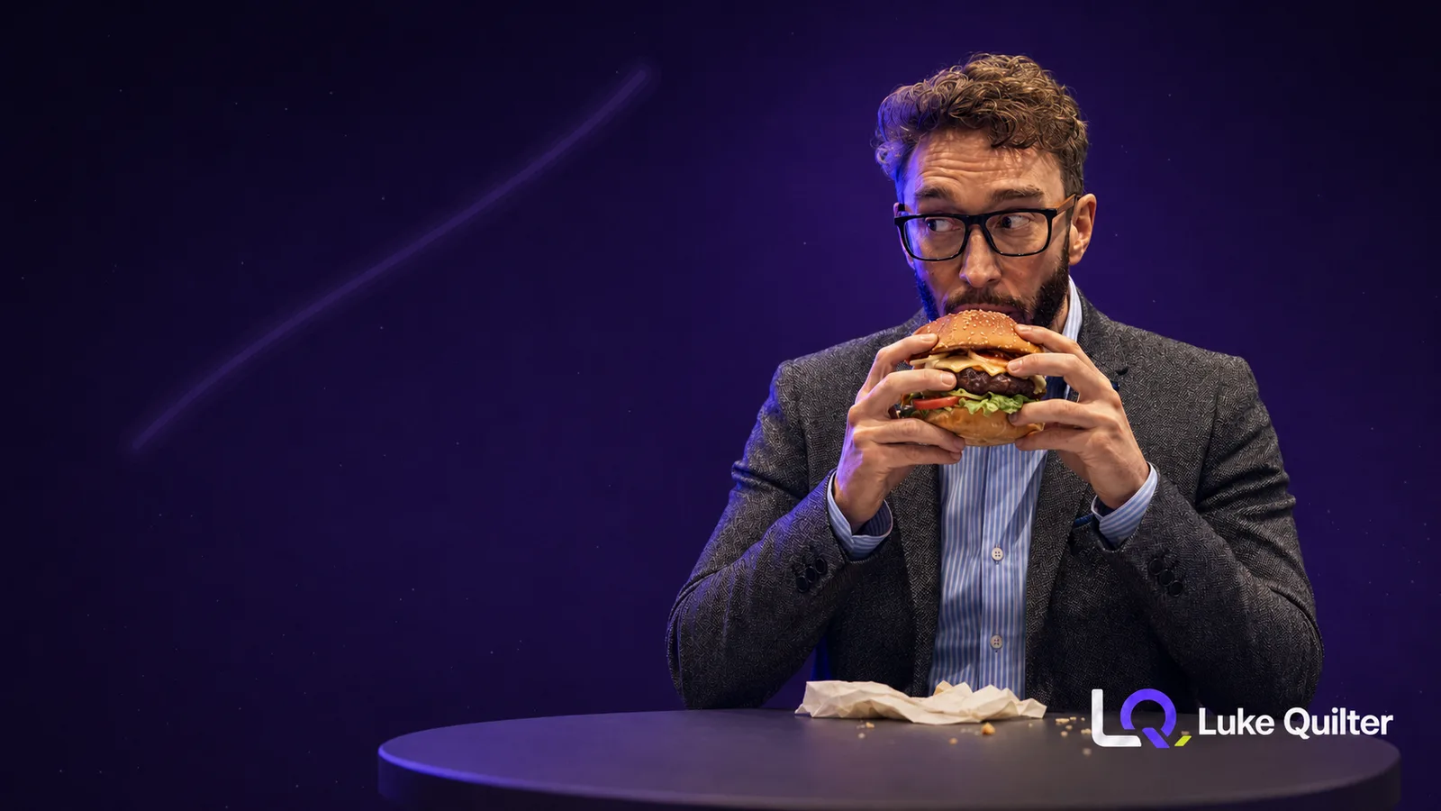 Luke Quilter in a blazer eating a cheeseburger against a purple studio background, the lunch choice with the water footprint of roughly 8.9 million AI prompts